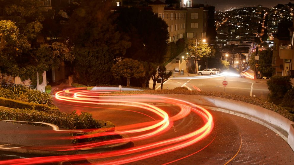 FILE - In this April 28, 2008 file photo, motorists wind their way down Lombard Street in San Francisco. Tourists may soon have to pay a fee to drive down San Francisco's world-famous crooked street. California officials plan to announce a proposal M