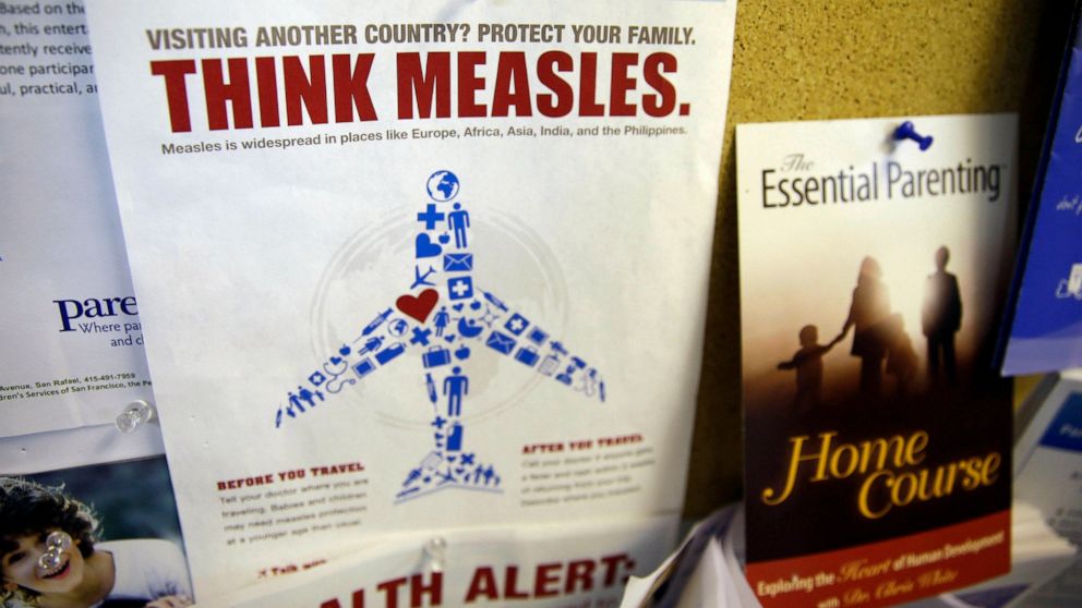 FILE - In this Feb. 6, 2015, file photo, a flyer educating parents about measles is displayed on a bulletin board at a pediatrics clinic in Greenbrae, Calif. State health officials say the number of measles cases is up in California in 2019 and much 