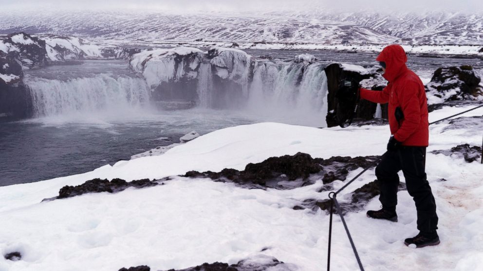 A tourist from Singapore photographs the Godafoss waterfall, a landmark view in northern Iceland, Dec. 16, 2018. Police in Iceland say tourists are often putting themselves at risk searching for the Northern Lights, whose spectacular streaks of color