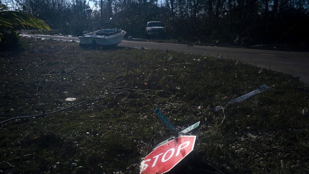 A traffic sign blown over by Hurricane Dorian lies on the ground in Pine Bay, near Freeport, Bahamas, Wednesday, Sept. 4, 2019. Rescuers trying to reach drenched and stunned victims in the Bahamas fanned out across a blasted landscape of smashed and 