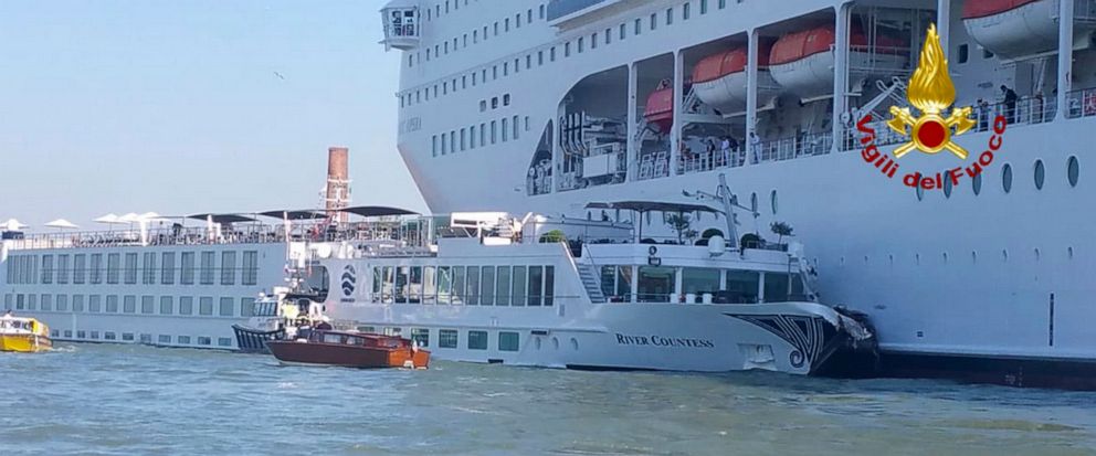 In this photo released by the Italian Firefighters, the MSC Opera cruise liner, a towering cruise ship, strikes a tourist river boat, left, Sunday, June 2, 2019, in Venice, Italy, injuring at least five people. The collision happened at about 8:30 a.