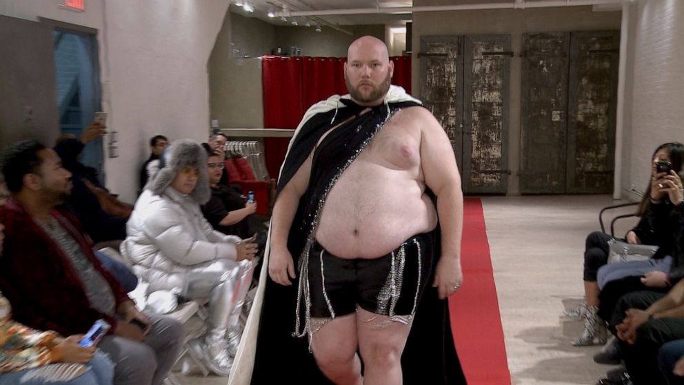 Joseph Diaz walks the runway in a fashion show Wednesday, Feb. 12, 2020, aimed at shining a light on male body shaming issues and the importance of the male body positivity movement. (AP Photo/Aron Ranen)