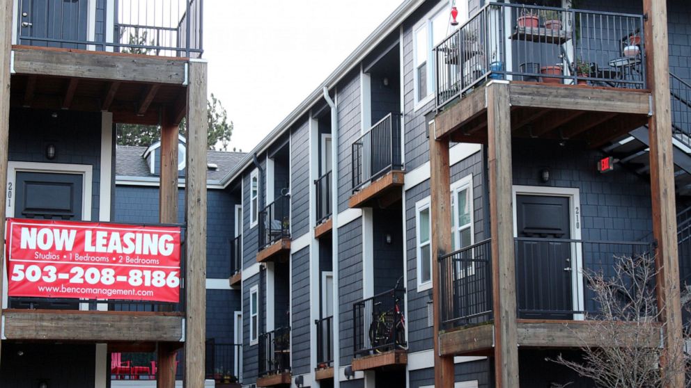 FILE - A 'Now Leasing' sign hangs off an apartment building staircase in southeast Portland, Ore., on Wednesday, Dec. 9, 2021. Rents are starting to come down after spiking to record levels this past summer, but experts are uncertain if the slowdown 