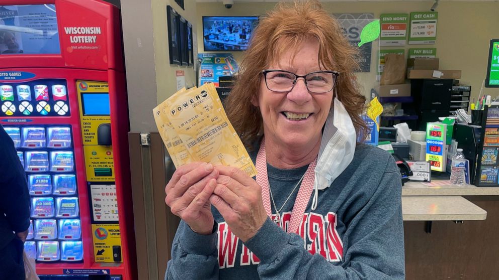 Pam DeBlois, 73, holds her Powerball tickets at a Pick 'n Save store in Madison, Wis., where she said she's bought most of her lottery tickets over the past several decades. The Powerball jackpot recently reached a record high of $1.6 billion. (AP Ph