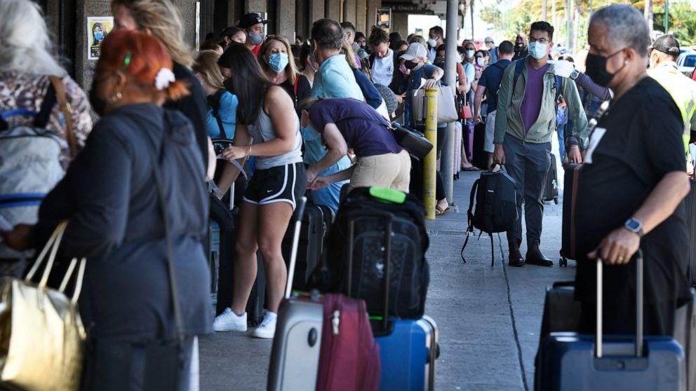 A long line of travelers wait to pass through a state agriculture inspection at the Kahului Airport on the Hawaiian island of Maui Thursday, June 3, 2021. The Hawaiian island of Maui has become so overrun with tourists in recent months that its mayor