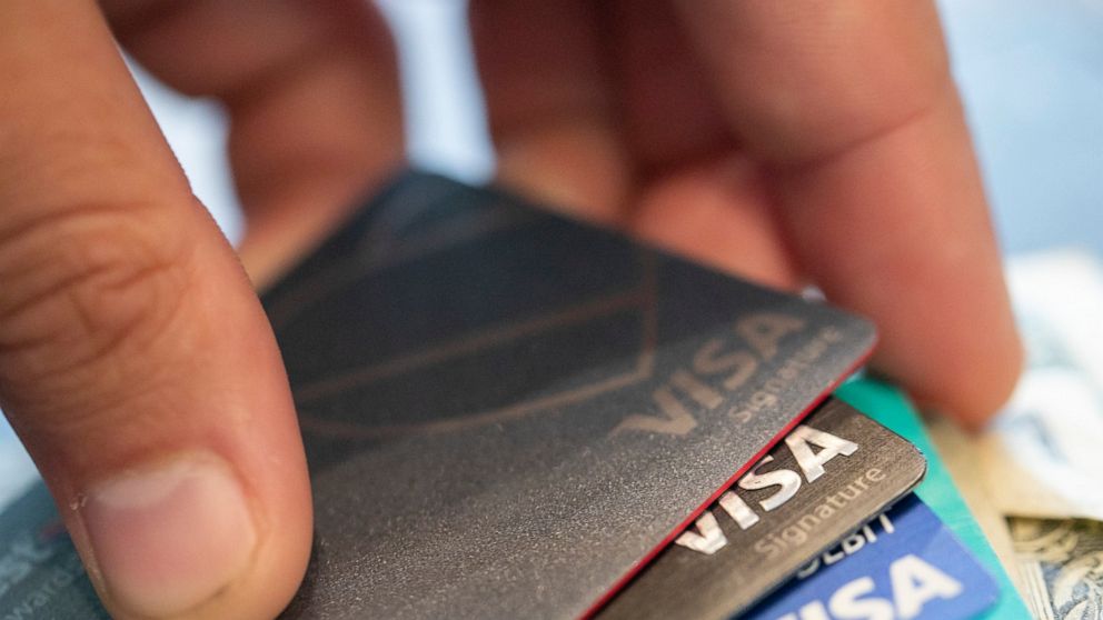 FILE - This Aug. 11, 2019 file photo shows Visa credit cards in New Orleans. A credit card’s fine print can more than strain your eyes; your wallet can also feel the pain if you don’t understand the terms. (AP Photo/Jenny Kane, File)