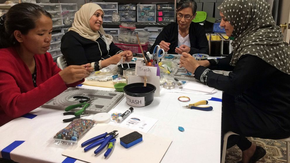 This May 15, 2019 photo shows A Little Something participants Khei Hung from Burma, left, Sabah Almobarak from Syria, Eh Gay Ju from Burma, and Mounira Kuru from Syria, as they work through frustration and creative challenges in their first lesson ma
