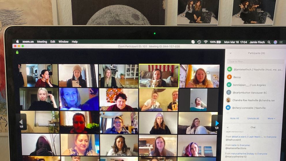 In this March 16, 2020 photo provided by Jamie Lee Finch, a laptop on a desk in Nashville, Tenn., showing people gathered together online for a virtual happy hour is shown. With bars shuttered and stressed-out workers stuck at home, companies and fri