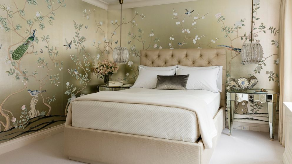 This undated photo provided by Craig & Company shows a master bedroom that interior designer Joan Craig designed for a New York client. Craig used a hand-painted Chinoiserie gilded silk from de Gournay. "Wallpaper is having its day," says Craig. "We 