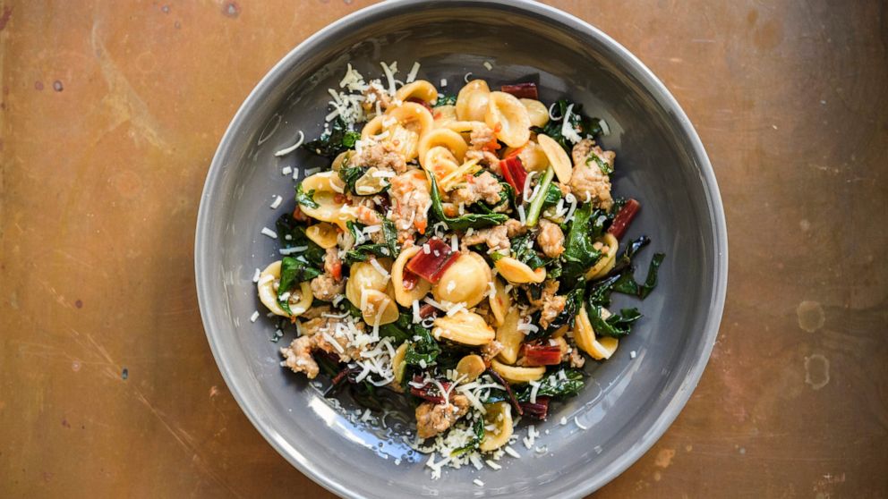 This image released by Milk Street shows a recipe for orecchiette with sausage and arugula. (Milk Street via AP)
