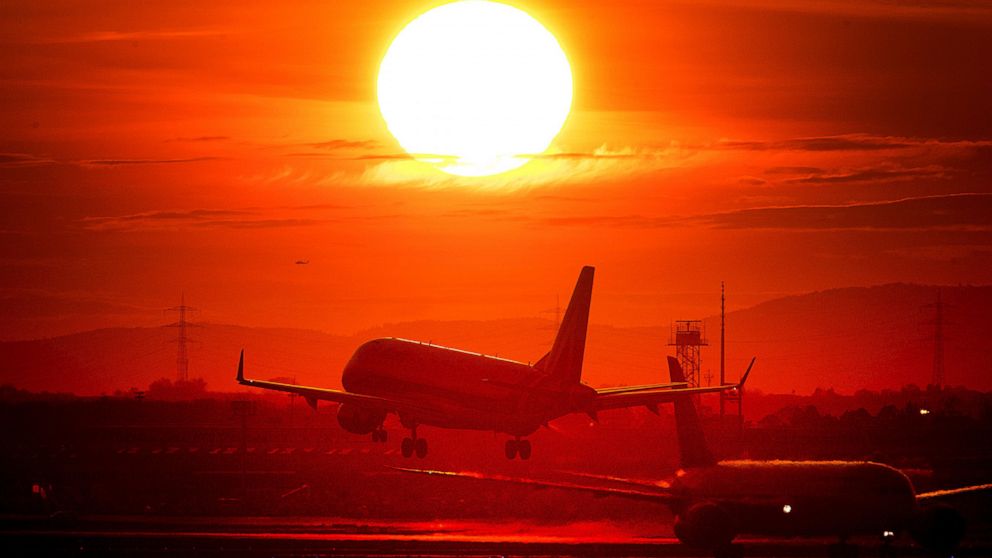 In this Wednesday, March 20, 2019 file photo an aircraft lands at the international airport in Frankfurt, Germany, as the sun sets. There is a small but growing movement in Sweden that's consciously shunning air travel because of its impact on the en
