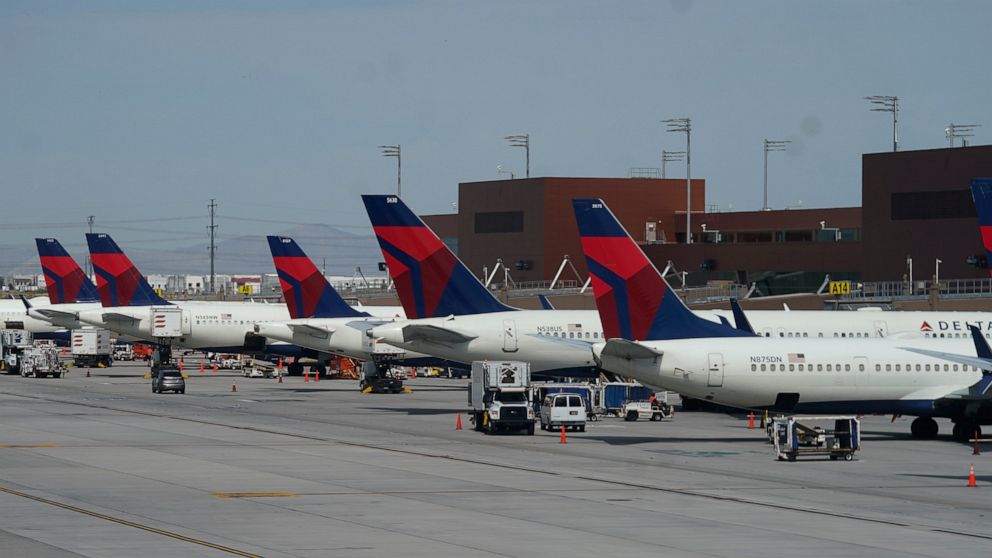 Delta Air Lines planes are shown at their gates at Salt Lake City International Airport Thursday, June 30, 2022, in Salt Lake City. Airlines that have stumbled badly over the last two holidays face their biggest test yet of whether they can handle bi