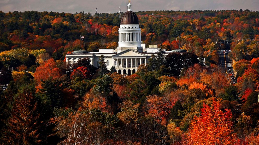 FILE - In this Oct. 23, 2017, file photo, the State House is surrounded by fall foliage in Augusta, Maine. Recent leaf-peeping seasons have been disrupted by weather conditions in New England, New York and elsewhere. Arborists and ecologists say the 