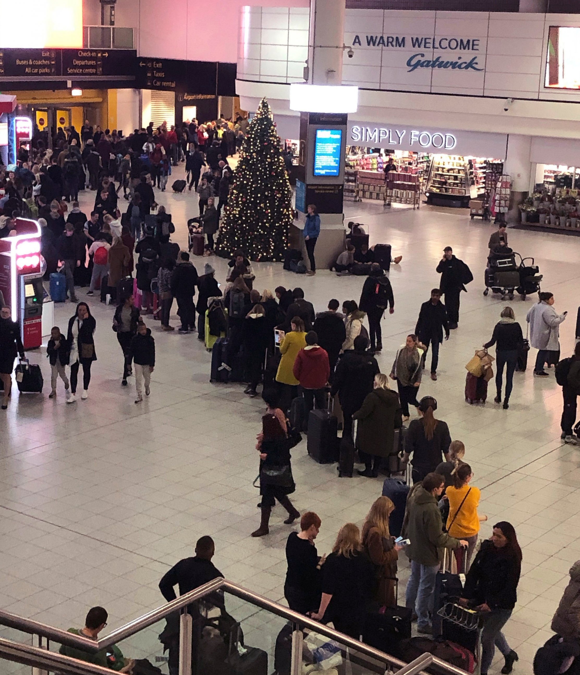 Queues of passengers cross a concourse in Gatwick Airport, as the airport remains closed with incoming flights delayed or diverted to other airports, after drones were spotted over the airfield last night and this morning Thursday Dec. 20, 2018. Lond