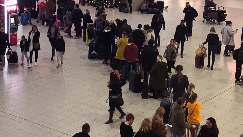 Queues of passengers cross a concourse in Gatwick Airport, as the airport remains closed with incoming flights delayed or diverted to other airports, after drones were spotted over the airfield last night and this morning Thursday Dec. 20, 2018. Lond