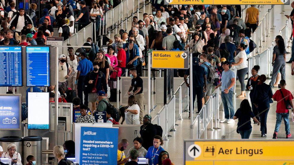People wait in a TSA line at the John F. Kennedy International Airport on Tuesday, June 28, 2022, in New York. (AP Photo/Julia Nikhinson)
