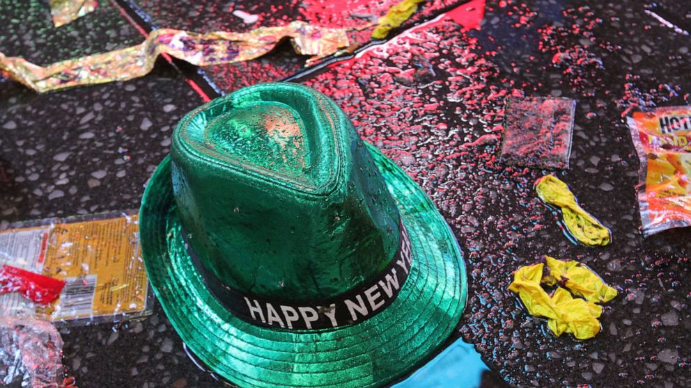 FILE - In this Jan. 1, 2019, file photo a "Happy New Year" hat lies on the wet ground along with other items following the celebration in New York's Times Square. Setting a New Year’s resolution about improving your finances is an excellent way to st