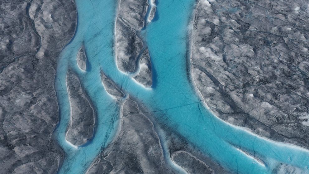 In this image taken on Thursday Aug.1, 2019 large rivers of melting water form on an ice sheet in western Greenland and drain into moulin holes that empty into the ocean from underneath the ice. The heat wave that smashed high temperature records in 