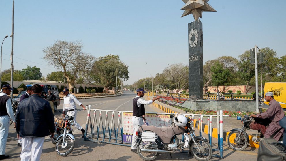 Pakistani police officers block a road to Karachi airport after it was close for civilian operations amid tension along the border with India, in Karachi, Pakistan, Wednesday, Feb. 27, 2019. Pakistan's military said Wednesday it shot down two Indian 