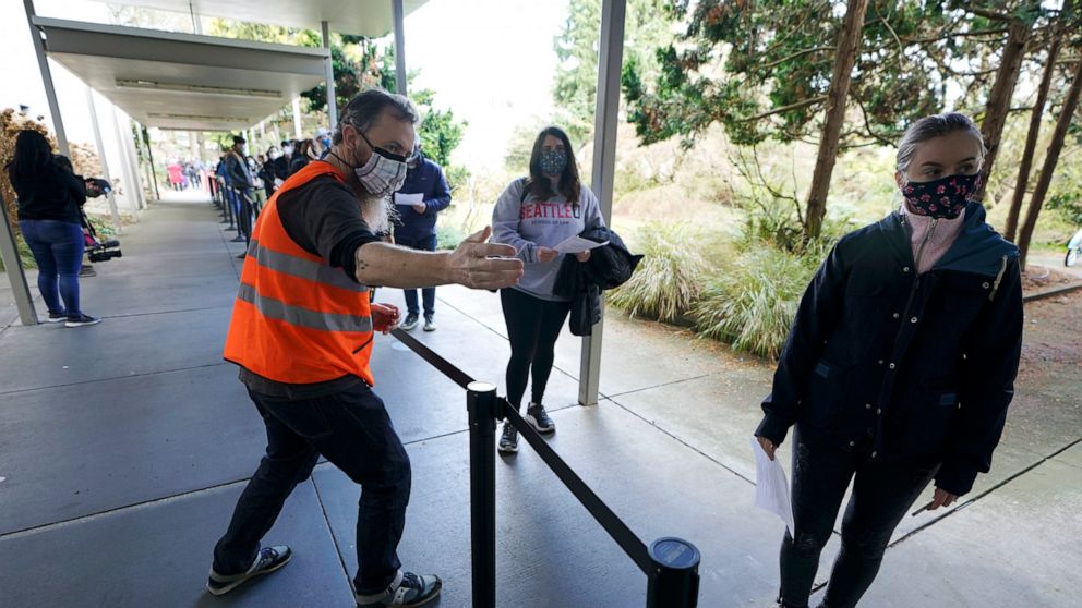 Volunteers are key at vaccine sites. It pays off with a shot - ABC News