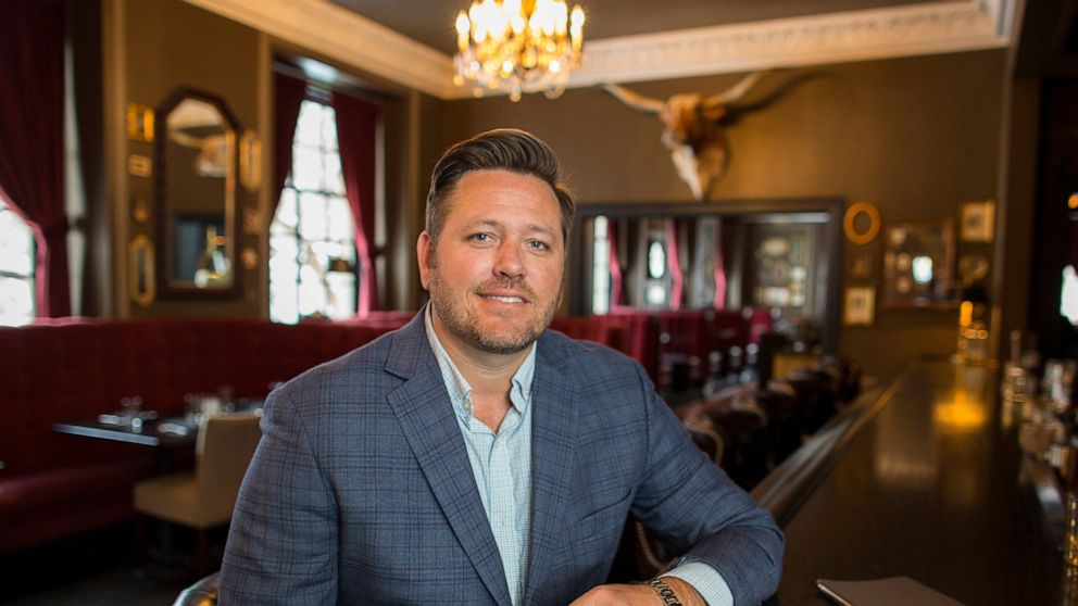 In this Feb. 11, 2020, photo, Brent Frederick, founder of Jester Concepts, a restaurant group in Minneapolis poses at P.S. Steak. Frederick puts a 3% voluntary surcharge on guest checks to help pay for health insurance and mental health services and 