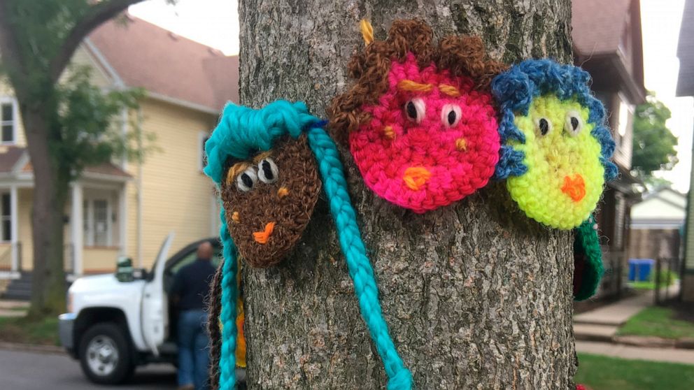 This July 2017 photo provided by yarn activist Hinda Mandell shows crochet emoji faces that Mandell installed outside of Susan B. Anthony's historic home, known as the National Susan B. Anthony Museum & House, in Rochester, N.Y., to coincide with the