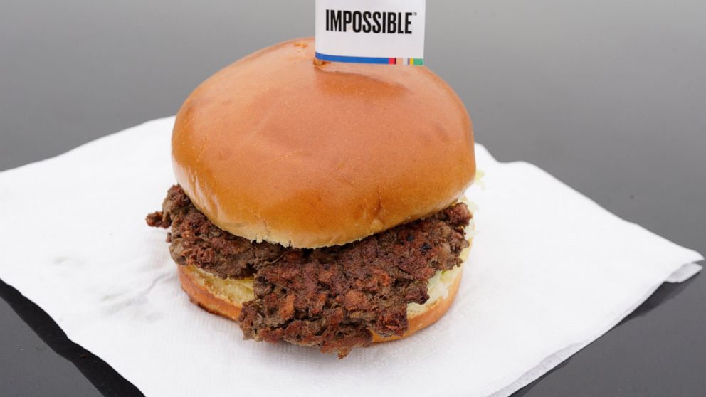 FILE- This Jan. 11, 2019, file photo shows the Impossible Burger, a plant-based burger containing wheat protein, coconut oil and potato protein among it's ingredients in Bellevue, Neb. From soy-based sliders to ground lentil sausages, plant-based mea