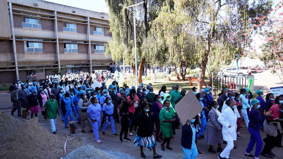 FILE -Health workers led by nurses take part in a demonstration over salaries at Parerenyatwa Hospital in Harare, on June, 21, 2022. As food costs and fuel bills soar, inflation is plundering people’s wallets, sparking a wave of protests and workers’