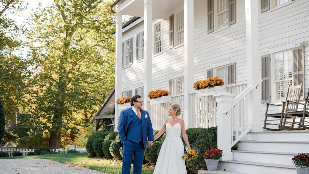 This photo shows Shelley Kapitulik-Jaye and her husband, Stephen Jaye, on Oct. 20, 2021, in Norwalk, Conn.. The two wed on a Wednesday, tapping into a trend of couples choosing weekdays for their weddings, either by choice or necessity. (Mindy Briar 