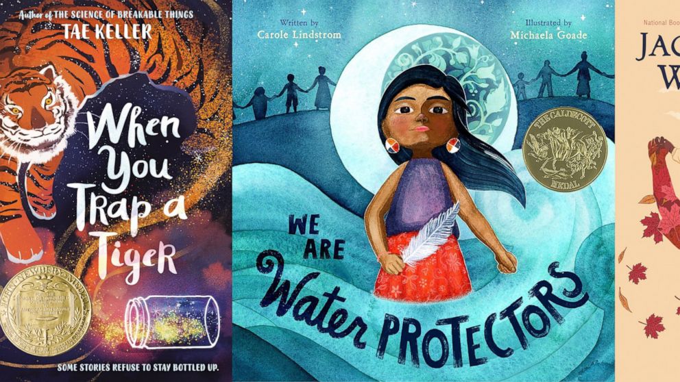 This combination of cover images shows, from left, "When You Trap a Tiger," winner of the John Newbery Medal for the outstanding children's book overall of 2020, "We Are Water Protectors," written by Carol Lindstrom and illustrated by Michaela Goade,