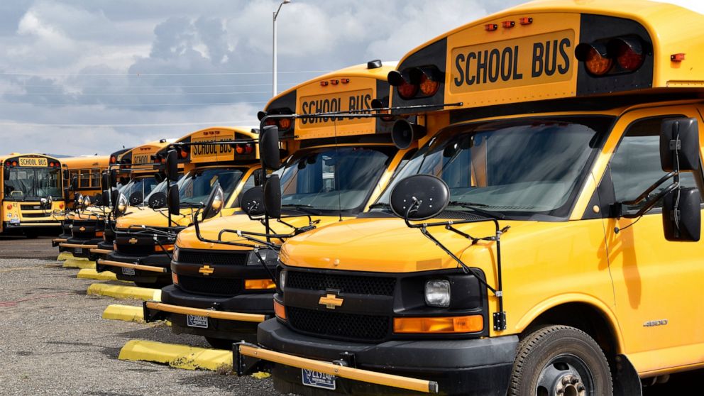 School buses parked in Helena, Mont., ahead of the beginning of the school year, Friday, Aug. 20, 2021. School districts across the country are coping with a shortage of bus drivers, a dilemma that comes even as they struggle to start a new school ye