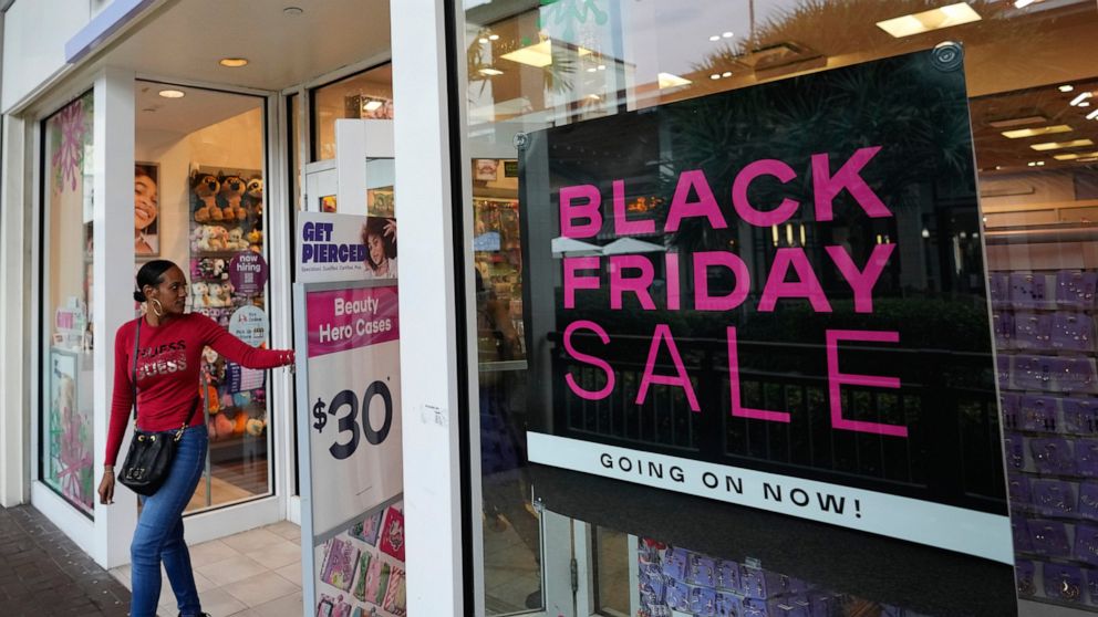 Shoppers exit a Claire's accessories store advertising sales ahead of Black Friday and the Thanksgiving holiday, Monday, Nov. 21, 2022, in Miami. Retailers are ushering in the start of the holiday shopping season on the day after Thanksgiving, prepar