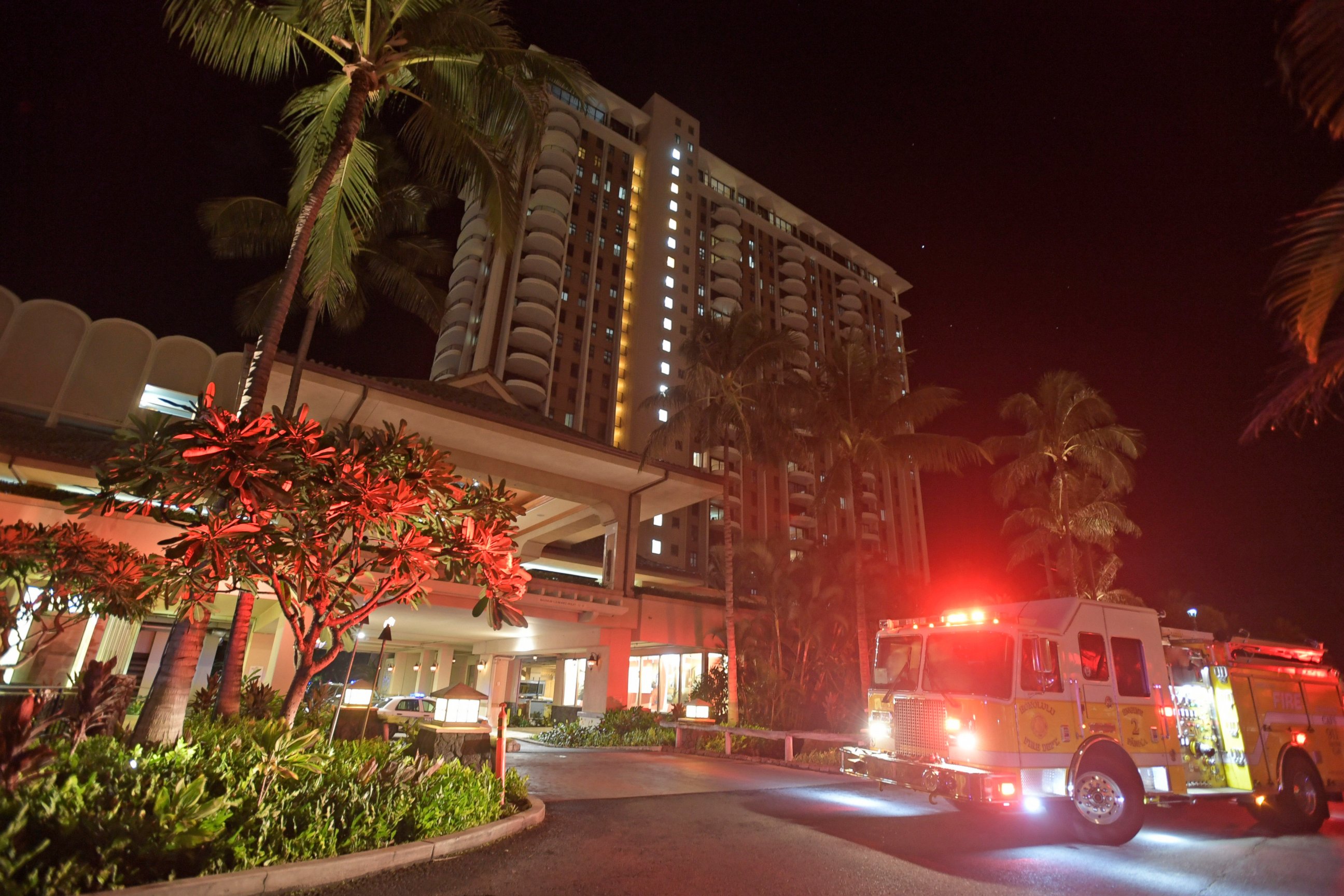 In this Tuesday, Aug. 6, 2019, photo, first responders from Honolulu Fire Department and Honolulu Police Department arrive at the Grand Waikikian in response to a fire reported on the 28th floor, in Honolulu. (Bruce Asato/Honolulu Star-Advertiser via AP)