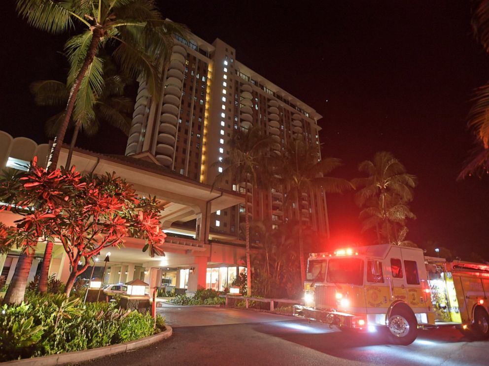In this Tuesday, Aug. 6, 2019, photo, first responders from Honolulu Fire Department and Honolulu Police Department arrive at the Grand Waikikian in response to a fire reported on the 28th floor, in Honolulu. (Bruce Asato/Honolulu Star-Advertiser via AP)