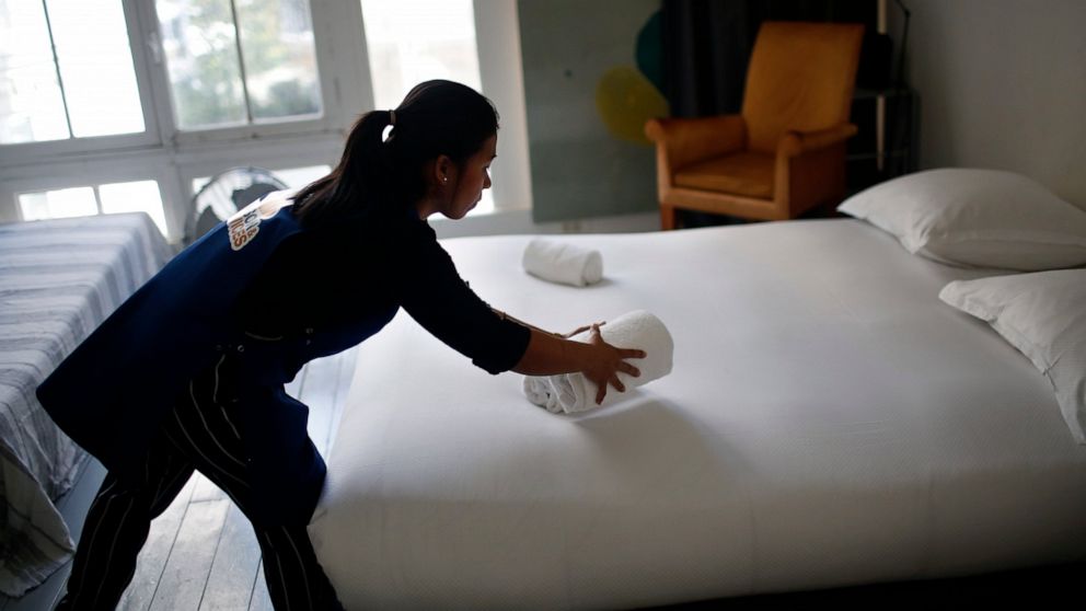 FILE - In this Thursday, Sept. 20, 2018 photo, a cleaning lady works in an apartment located on Airbnb in Paris. Airbnb hosts are facing an onslaught of frustrations born of renting out their properties to short-term guests. Certain guests have prove