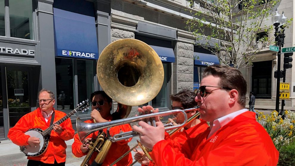 Dan Gabel, right, and fellow musicians perform in downtown Boston, Tuesday, May 10, 2022. Gabel has canceled Netflix and other streaming services and tried to cut back on driving as the costs of gas, food, and other items, such as the lubricants he u
