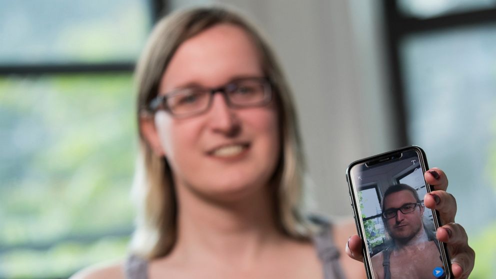 In this Wednesday, May 15, 2019, photo, Bailey Coffman shows her photo as a man in the Snapchat app during an interview in New York. Snapchat's new photo filter that allows users to change into a man or woman with the tap of a finger isn’t necessaril