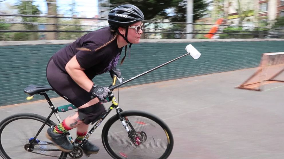 Bike polo player races across the "Polo Pit" on the Lower East Side of Manhattan.