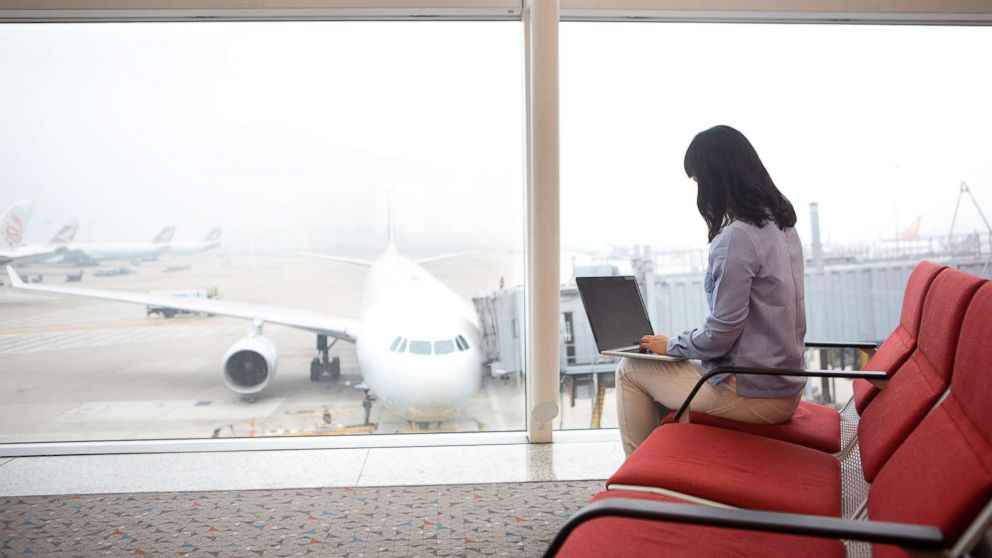 Woman at airport using laptop in an undated stock photo.