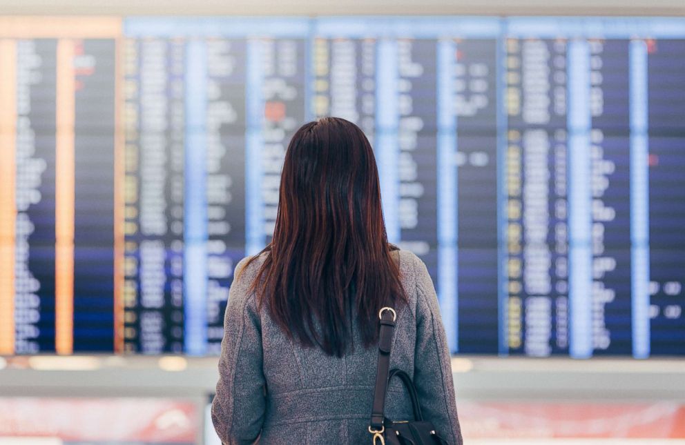 PHOTO: A woman checks arrivals and departures at the airport terminal in this undated stock photo.