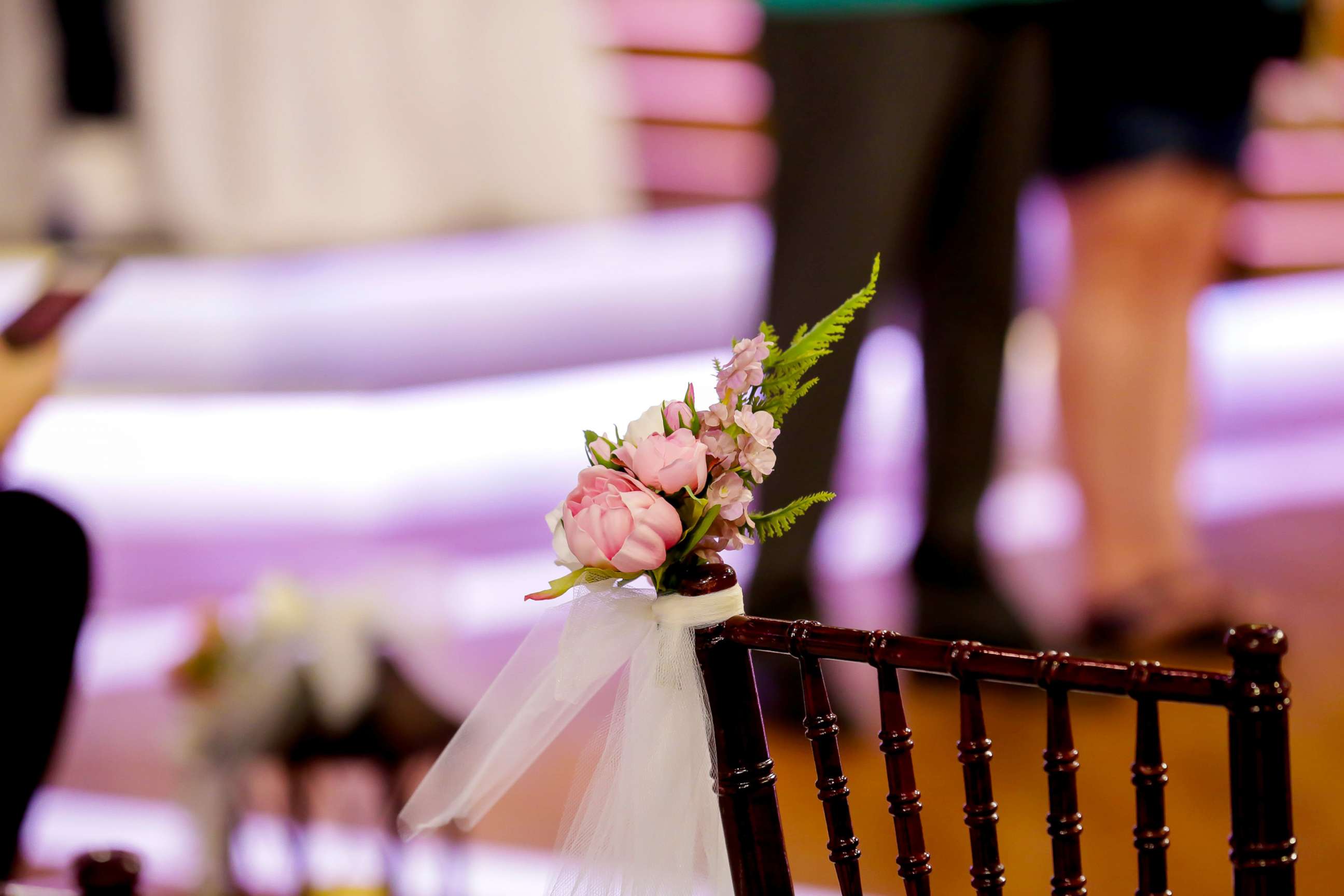 PHOTO: Chairs are decorated with flowers and tulle