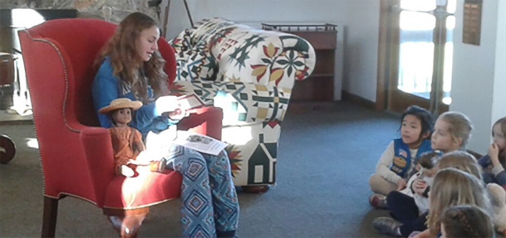 PHOTO: Olivia Reduto reads an American Girl story to younger Girl Scouts.