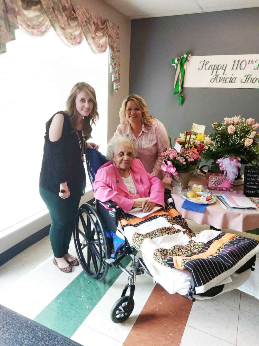 PHOTO: Stratford Activities Director Kim Holley and Director of Nursing Karen Baise flank Avicia Thorpe while posing for a photo at her birthday celebration in Danville, Va., April 16, 2018.
