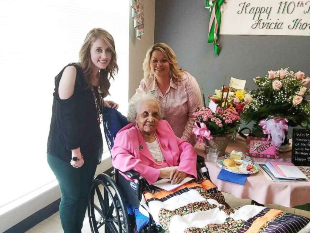 PHOTO: Stratford Activities Director Kim Holley and Director of Nursing Karen Baise flank Avicia Thorpe while posing for a photo at her birthday celebration in Danville, Va., April 16, 2018.