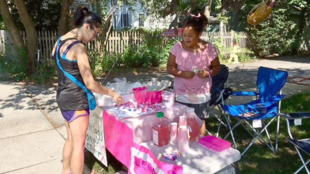 Olivia Ohlson, 10, sells baked goods to a customer at a bake sale she held in her Evanston, Illinois, neighborhood.