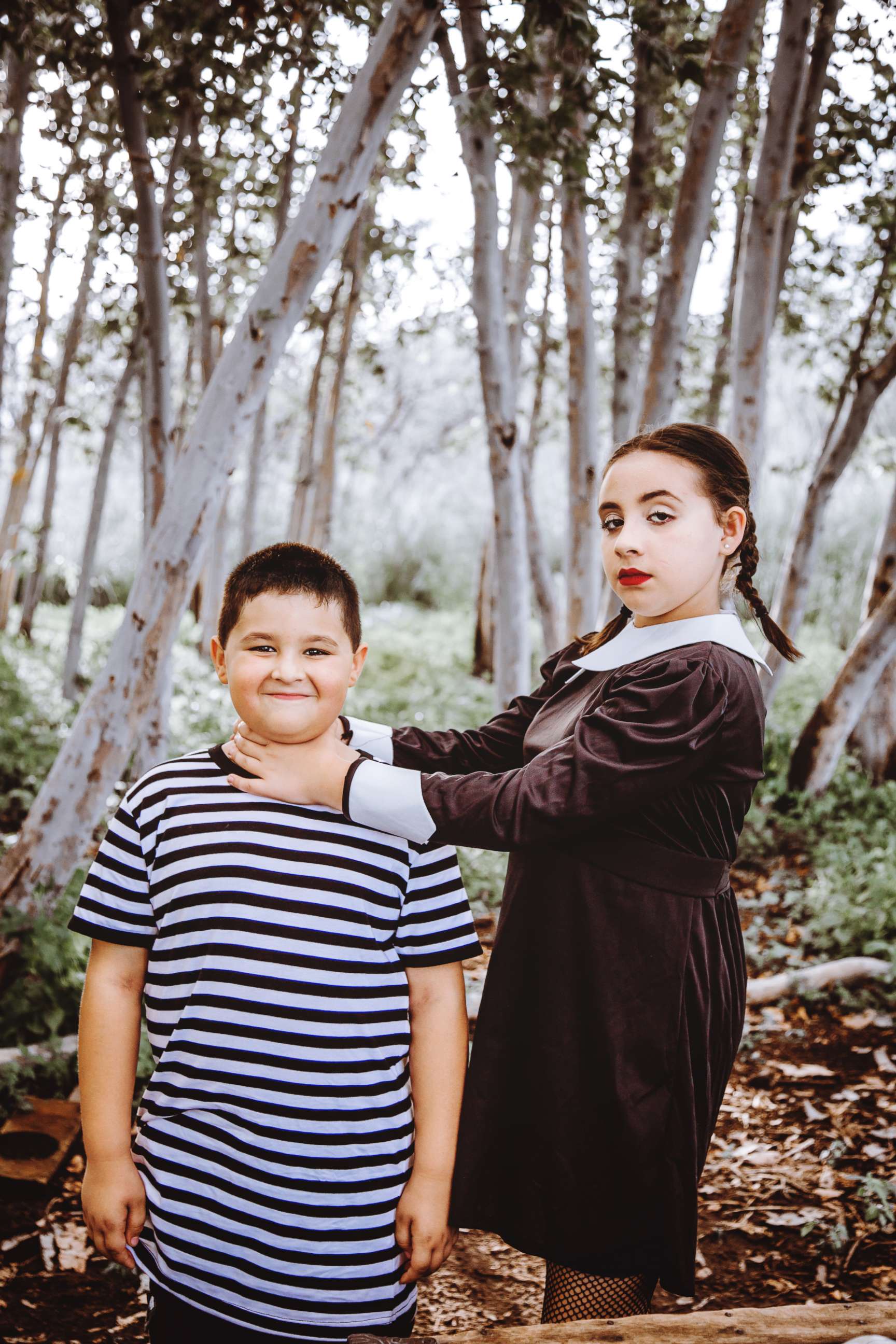 PHOTO: Maxwell and Madison Basteen pretend to be Pugsley and Wednesday Addams in their family's photo shoot.