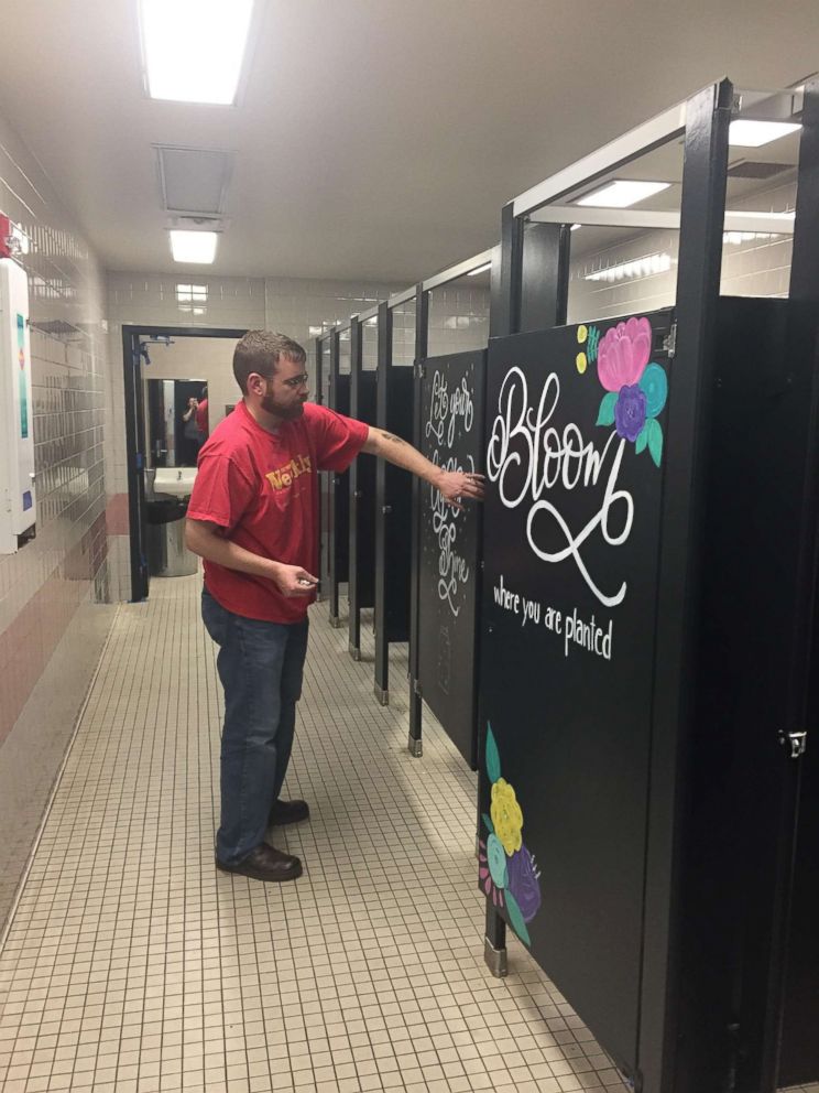 PHOTO: The father of a Mary Moore Elementary School student helps to decorate the school's bathrooms.