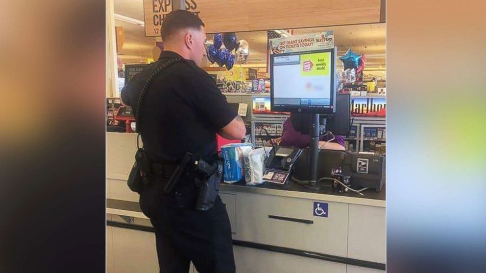 Rookie Laurel police officer Bennett Johns bought diapers for a woman caught shoplifting in order to care for her son, July 22, 2017.