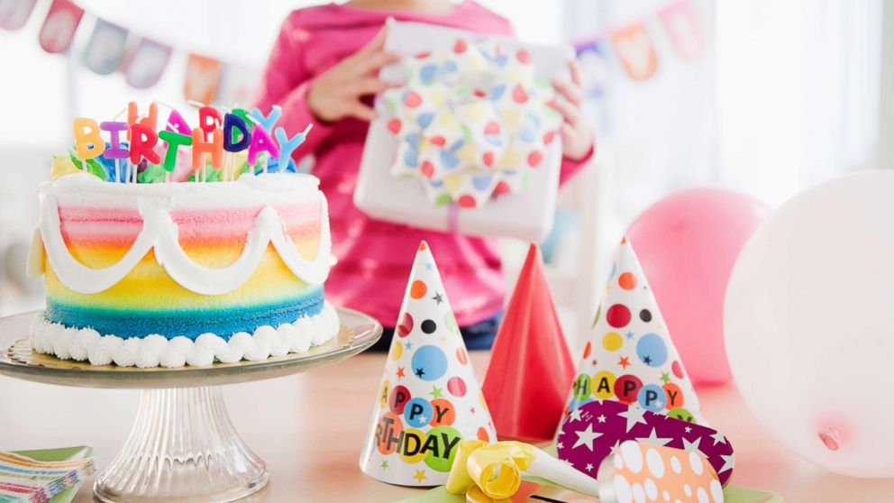 A girl holds a gift at birthday party in this undated stock photo.