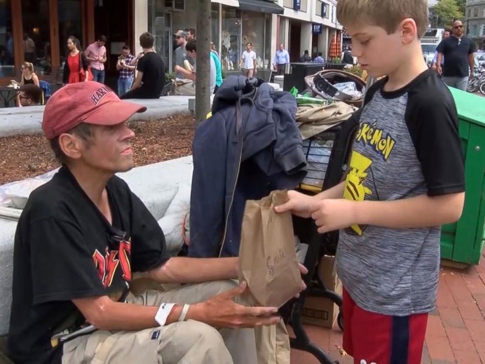 PHOTO: Liam Hannon, 10, hands out homemade lunches to the homeless population of Cambridge, Massachusetts, along with help from his father, Scott Hannon.